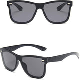 Black sunglasses with dark lenses on a white background